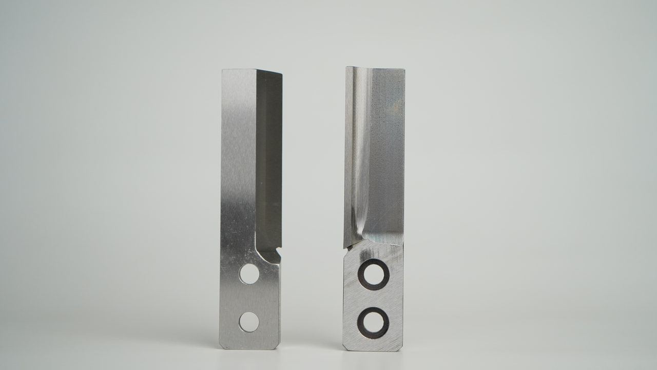 Two finished pelletizer knives on a neutral background
